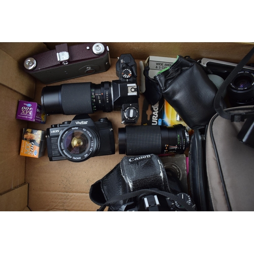 202 - A collection of vintage 35mm SLR cameras and lenses to include, Canon A-1 camera with Canon lens FD ... 