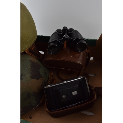 207 - A mixed collection of items to include military helmet, vintage motorcycle helmet, camera and binocu... 