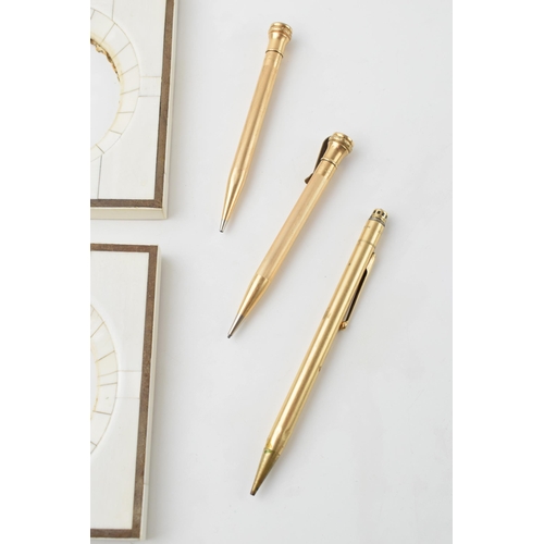 211 - A trio of gold plated Eversharp USA propelling pencils with a pair of vintage marble effect frames (... 