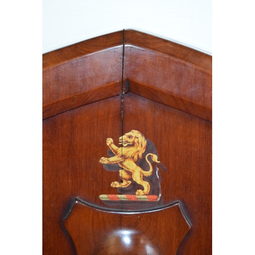 217 - A pair of antique mahogany hall chairs with lion emblem and shaped backs, 92cm tall (2).