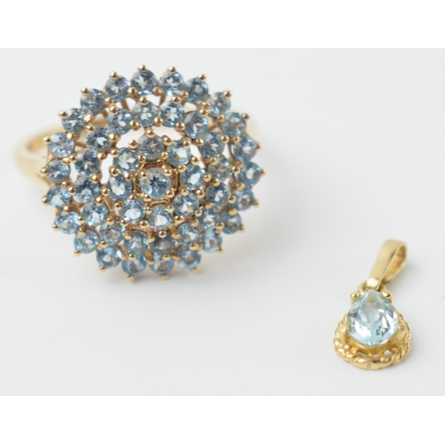 581 - 9ct gold ring set with light blue stones together with a matching pendant, 3.8 grams (2).