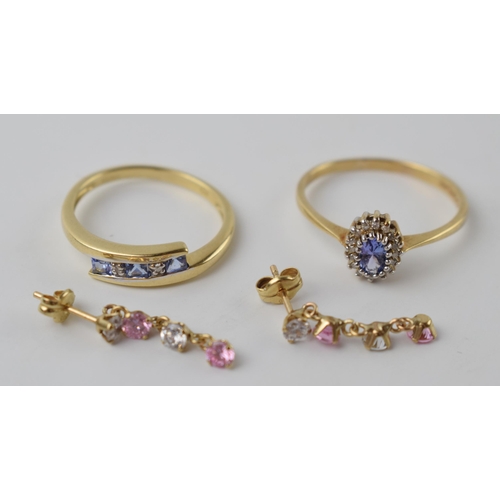 596 - 9ct gold pair of earrings with a crossover ring, size O, with a pale stone and illusion set diamond ... 