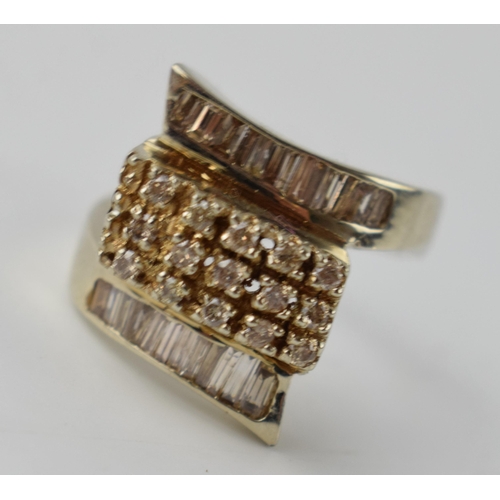 613 - 14ct gold ring set with diamonds of varying styles, 8.9 grams, size P.