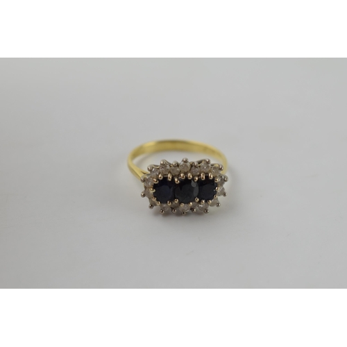 614 - 18ct gold ring set with synethetic sapphires and CZs, 3.6 grams, size L/M.