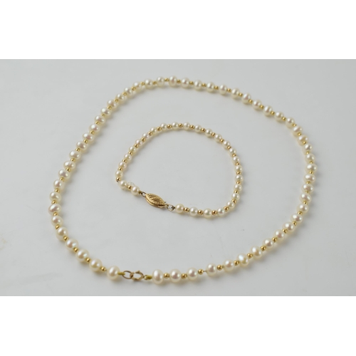 615 - A pearl necklace, set on a 9ct gold clasp, length 40.5cm, with a similar bracelet, length 19.5cm (2)... 