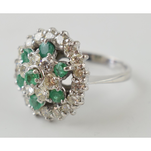 633 - 18ct gold ring set with 1.5ct of diamonds and emeralds, size 7.2 grams, size L/M.