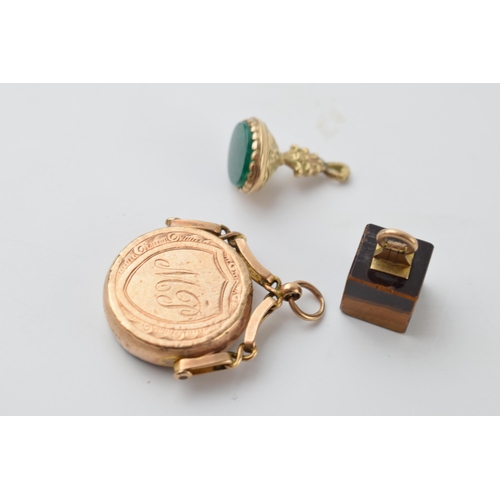 641 - A trio of 9ct gold fobs to include an agate swivel fob, a smaller fob and a 9ct gold mounted tigers ... 