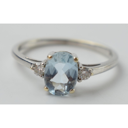 645 - 9ct white gold ring set with aqua marine and diamonds, 2.1 grams, size R.