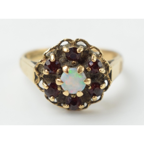 652 - 9ct gold ring to include 6 garnets surrounding an opal, 3.4 grams, size N/O.