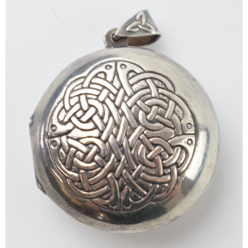 653 - Silver 925 circular locket with Celtic design and verse to rear, 'may the road rise to meet you', 11... 