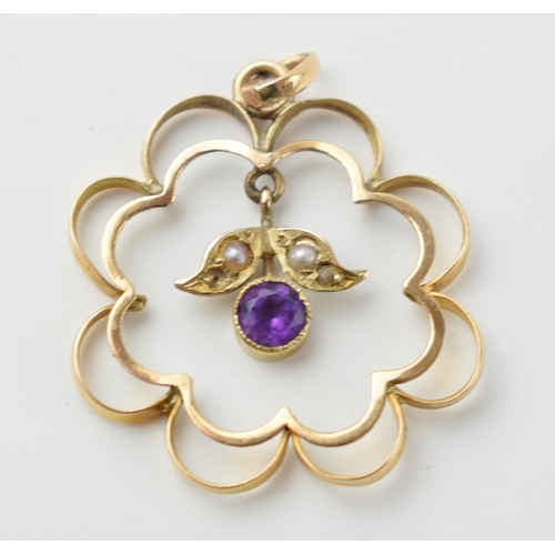 660 - Edwardian 9ct gold scroll framed pendant set with an amethyst and seed pearls, 1.4 grams.