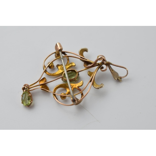 663 - 9ct gold Art Nouveau peridot and seed pearl pendant / brooch, 5.5cm tall, 3.4 grams.