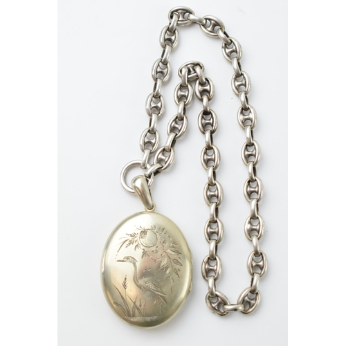 665 - Victorian locket with heron decoration to front, on chunky silver chain (tests as), gross weigh 33.3... 