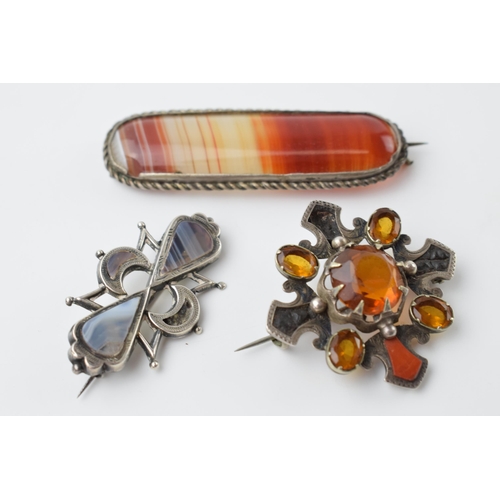 671 - A trio of silver and agate brooches of varying designs (3), largest 7cm wide.