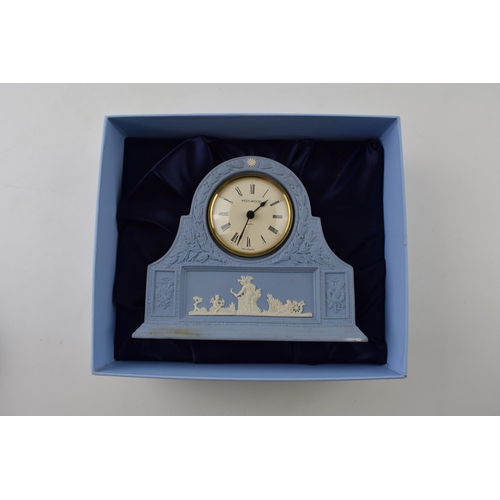 162 - Boxed Wedgwood Jasperware in blue mantle clock with traditional moulded relief, 16cm wide.