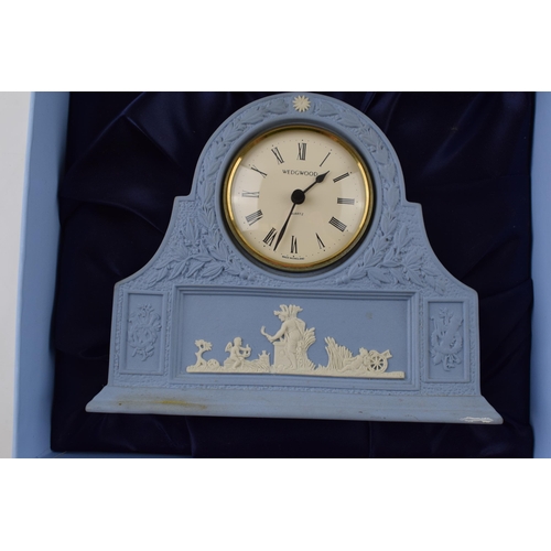 162 - Boxed Wedgwood Jasperware in blue mantle clock with traditional moulded relief, 16cm wide.