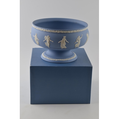 163 - Boxed Wedgwood Blue Jasperware pedestal bowl decorated with Dancing Hours relief, 23cm diameter.