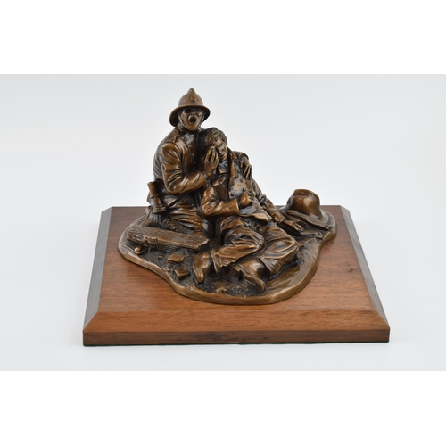 212 - A contemporary bronzed composition model of a fireman and accident victim, 'Fallen Comrade' signed A... 