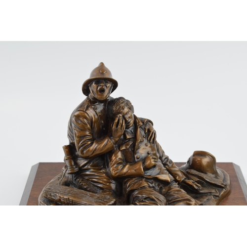 212 - A contemporary bronzed composition model of a fireman and accident victim, 'Fallen Comrade' signed A... 