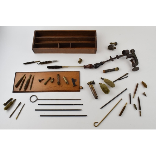 286 - A collection of vintage gun cleaning and cartridge making accessories to include rods, brushes and v... 