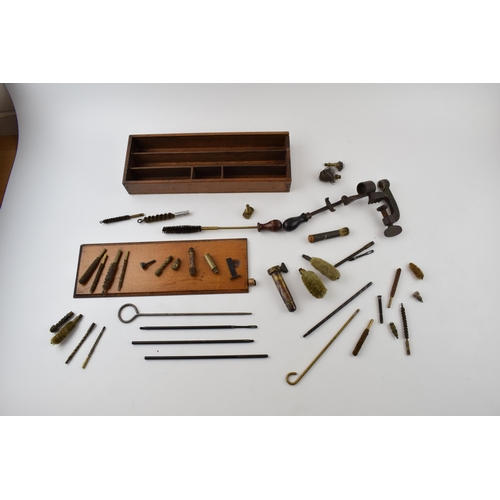 286 - A collection of vintage gun cleaning and cartridge making accessories to include rods, brushes and v... 