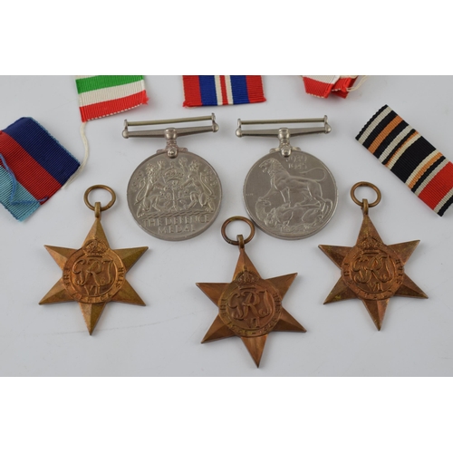 388 - A collection of WWII medals to include The 1939 - 1945 Star, Africa Star, Italy Star, Defence Medal ... 