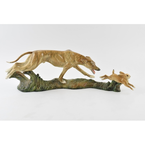 41 - Elite Pottery hunting scene tableau in the form of lurcher chasing hare, length 48cm.