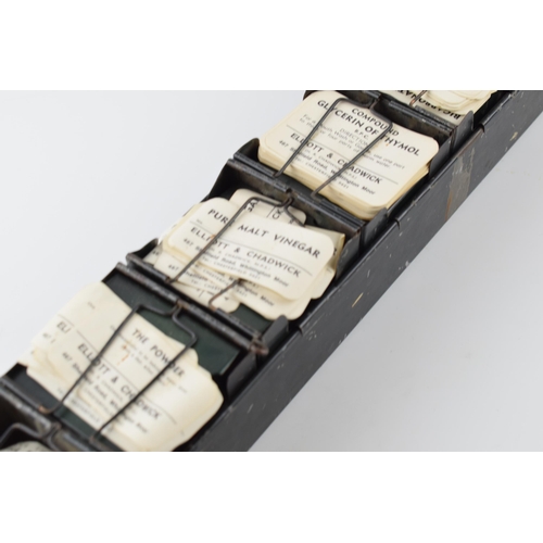 297 - 'The Alchemist Label Rack' with 6 sections for holding paper bottle labels, 43.5cm long, with some o... 