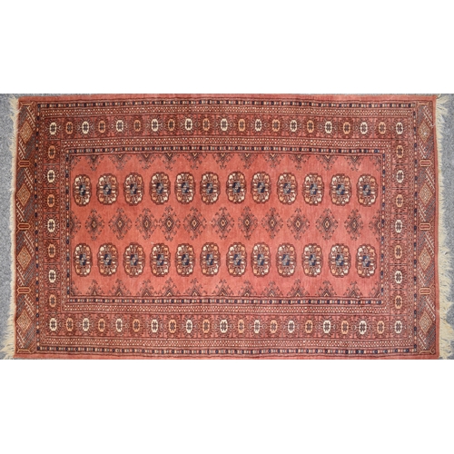 185 - Hand-knotted middle eastern carpet in deep reds, purples, blues and creams. Dimensions 140cm x 93cm.