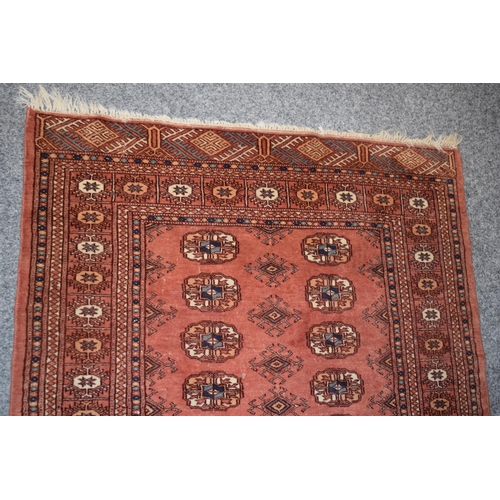 185 - Hand-knotted middle eastern carpet in deep reds, purples, blues and creams. Dimensions 140cm x 93cm.