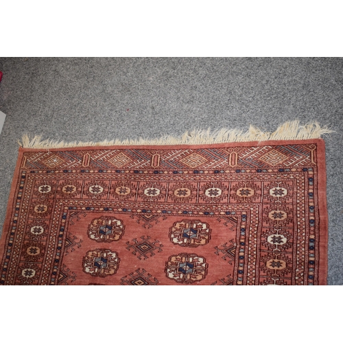 185 - Hand-knotted middle eastern carpet in deep reds, purples, blues and creams. Dimensions 140cm x 93cm.