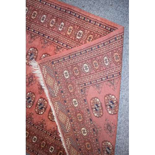 185 - Hand-knotted middle eastern carpet in deep reds, purples, blues and creams. Dimensions 140cm x 93cm.