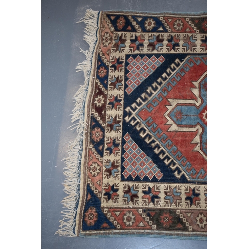 185A - Vintage Turkish hand-knotted carpet with traditional pattern in reds, blues, creams and browns, 109x... 