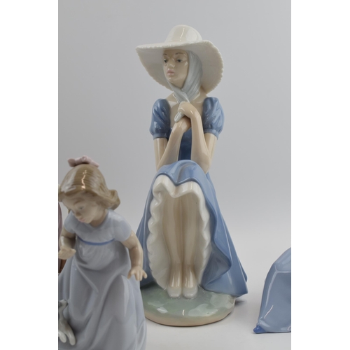 103 - Nao by Lladro to include girl sitting with straw hat, a girl with a puppy, girl with a bird and a gi... 