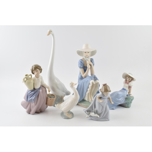 103 - Nao by Lladro to include girl sitting with straw hat, a girl with a puppy, girl with a bird and a gi... 