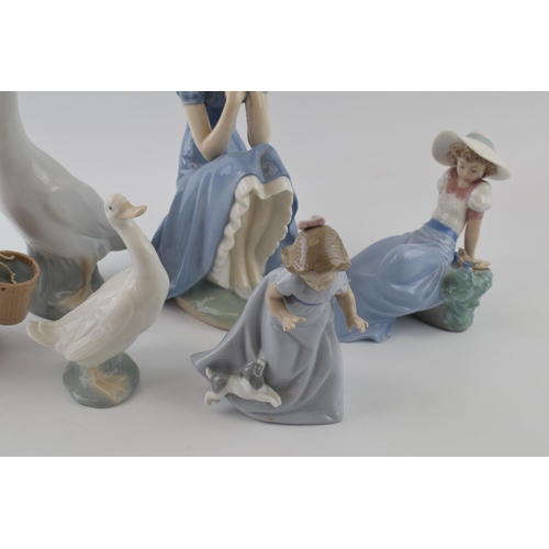 103 - Nao by Lladro to include girl sitting with straw hat, a girl with a puppy, girl with a bird and a gi... 