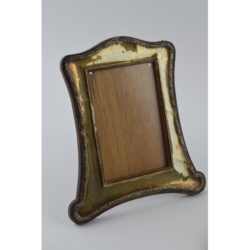 225 - Silver fronted photo frame, Birmingham 1911, 23cm tall, with a silver brush (2).