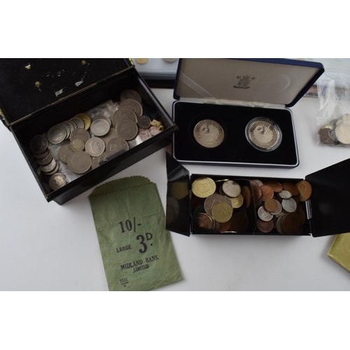 230 - A collection of coins of varying ages and denominations from the UK and across the world, some in an... 