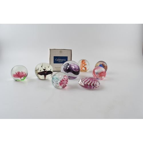 316 - A collection of glass paperweights to include a boxed example by Caithness, Scotland. (8)