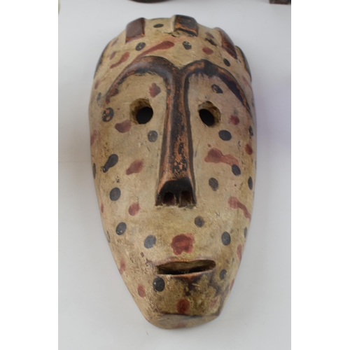 339 - Interesting items to include a carved tribal bust, a tribal wooden mask, a Crawfords biscuit tin, a ... 