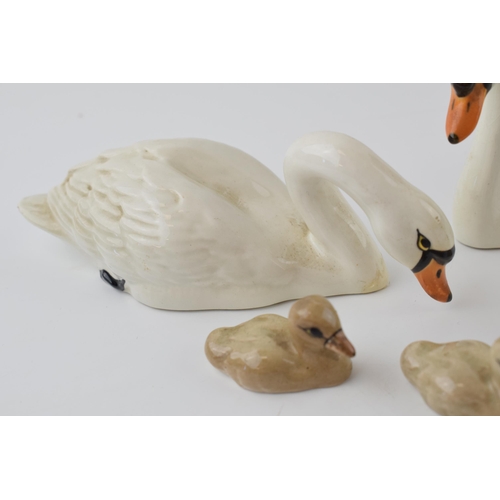 55 - Beswick to include a trio of cygnets, with a pair of swans (minor nips to swans), 1684 and 1685 (5).