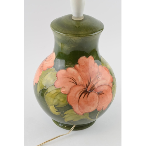 134 - Large Moorcroft Hibiscus on green bulbous lampbase, 33cm tall inc fittings.