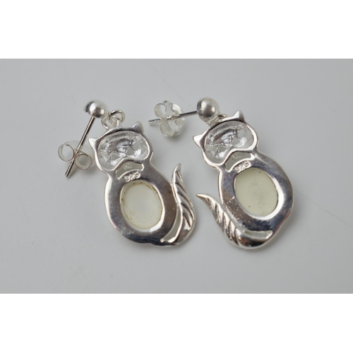 241 - A pair of sterling silver earrings in the form of cats with opal style inserts (2).