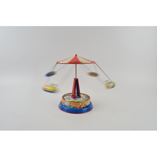 391 - Tinplate mechanical roundabout 'Spaceships Ride' . Height 19cm.