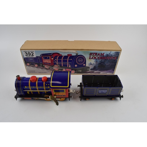 392 - Tinplate clockwork Steam Locomotive in box with key. Height 9cm.