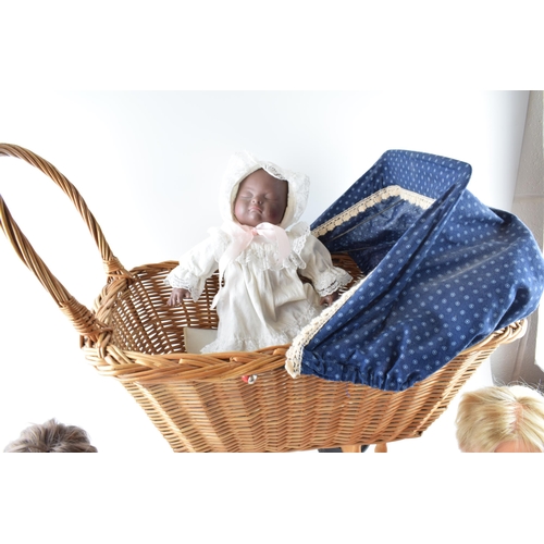 404 - A vintage wicker childs pram with Tiny Tears and Tiny Tim dolls together with an additional doll (4)