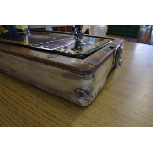 414 - A Singer Sewing Machine in it's original carry case. Serial No. EJ453345.