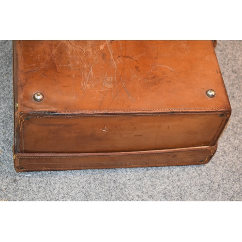 419 - An early 20th century Fortnum and Mason 'Cruzer' leather suitcase with metal fixings and leather han... 