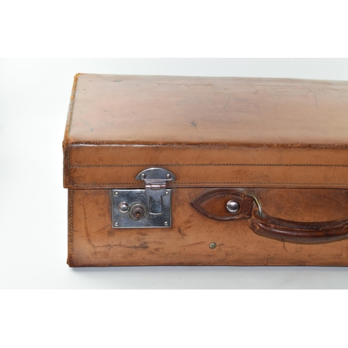 419 - An early 20th century Fortnum and Mason 'Cruzer' leather suitcase with metal fixings and leather han... 