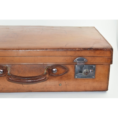 419 - An early 20th century Fortnum and Mason 'Cruzer' leather suitcase with metal fixings and leather han... 